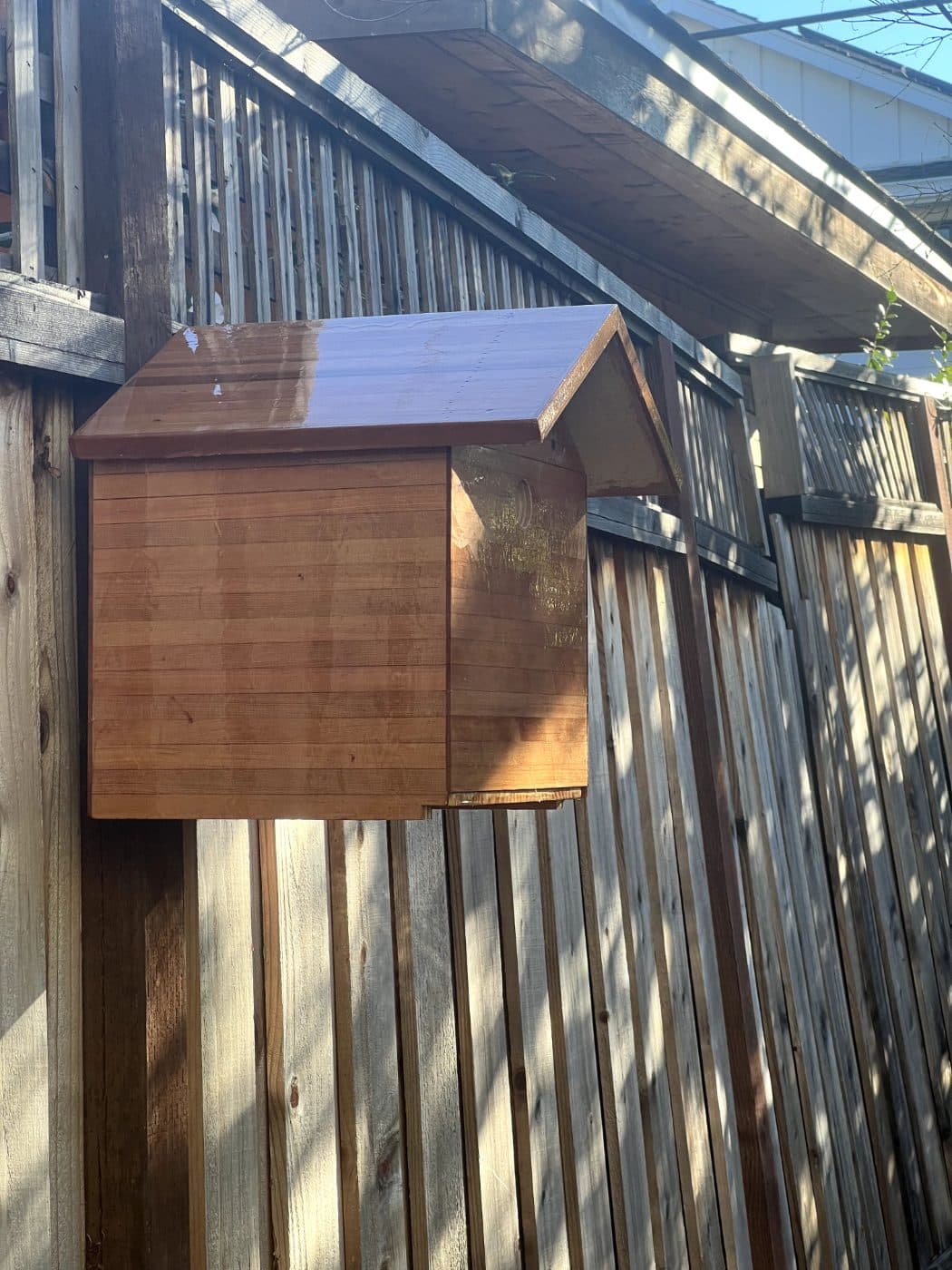 Cedar strip fence-mounted birdhouse